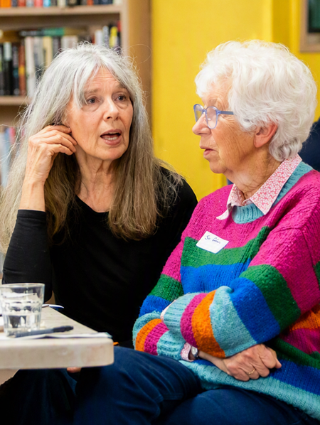 Two people chatting at a community energy workshop