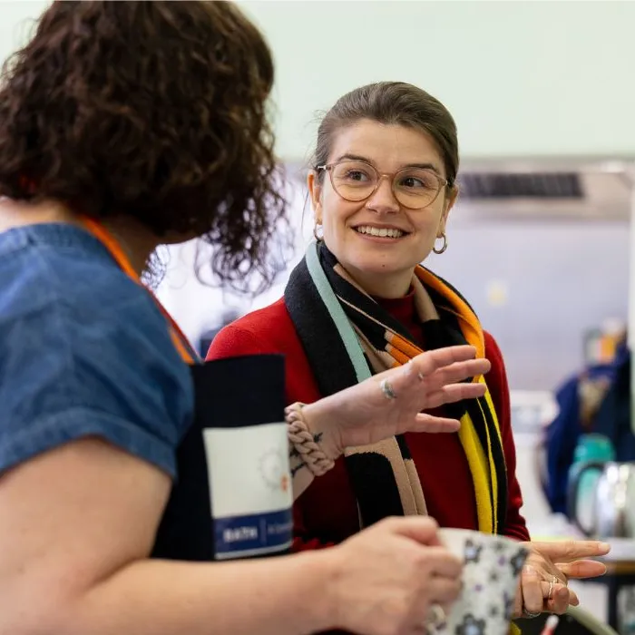 Two people talking at a home energy event
