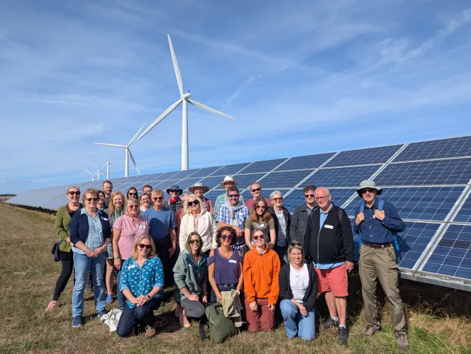 Community Energy group with solar panels and wind turbines