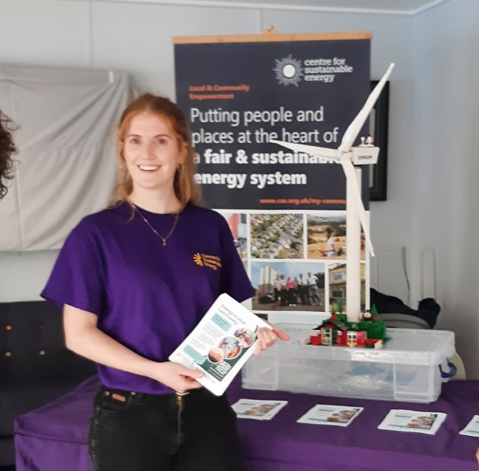 Centre for Sustainable Energy stall with charity staff and a model of a wind turbine
